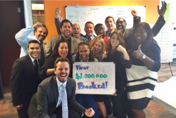Team celebrating their first million booked