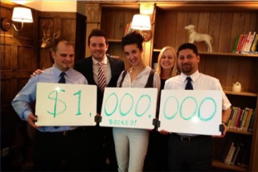 Team holding the first-million sign